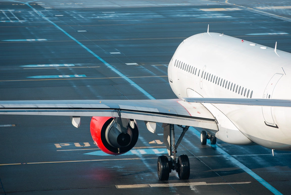 Photo of a white plane on a runway.
