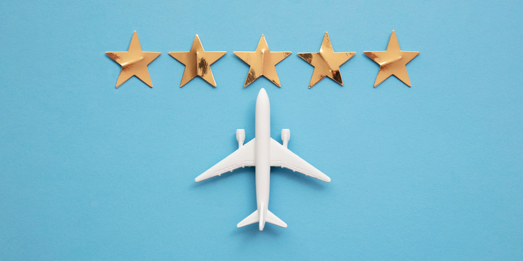 A model white plane on a blue background with 5 gold stars above it.