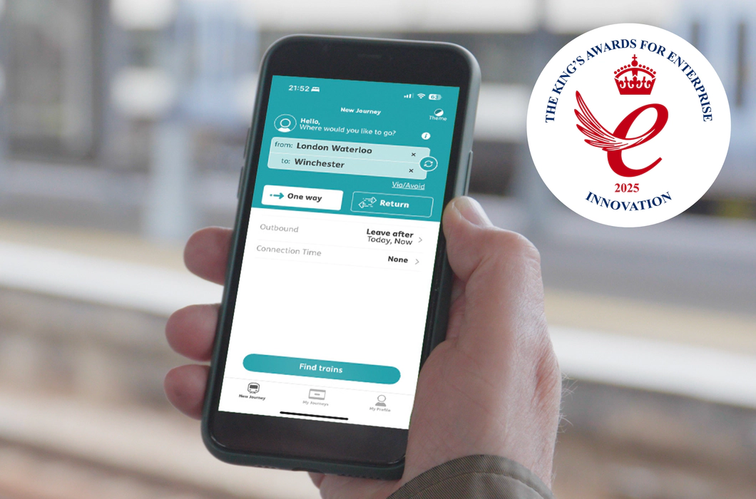 On the left, a teal background with Transreport logo in white and the King’s Awards for Enterprise 2025 Innovation emblem are displayed. On the right, a person uses the Passenger Assistance app on a smartphone to plan a train journey from London Waterloo to Winchester.