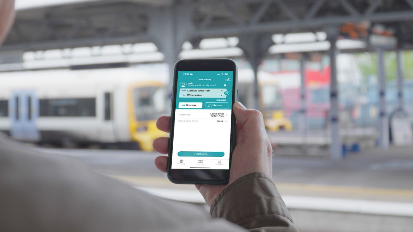 A woman holds a smart phone showing a summary of her Passenger Assistance request.